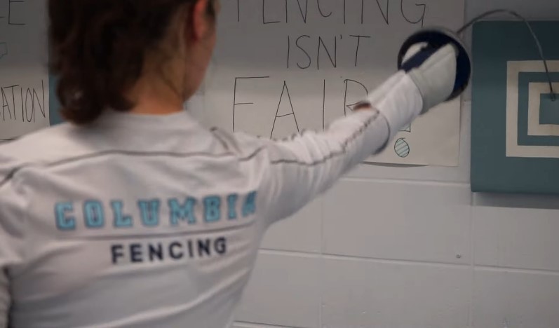 A fencer in action, practicing technique against a marked target