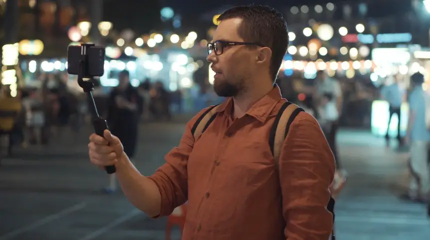 A man filming the bustling NYC night