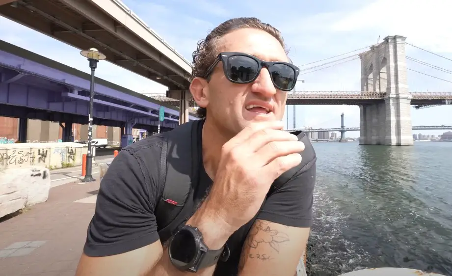 Casey Neistat, soaking in the city's energy, with the Brooklyn Bridge as a backdrop