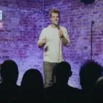 Comedian performing stand-up comedy at the Cracked Comedy Club