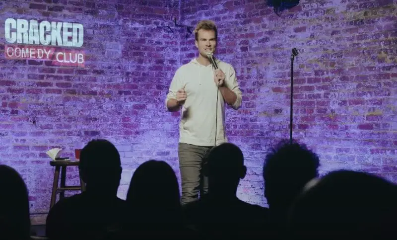 Comedian performing stand-up comedy at the Cracked Comedy Club