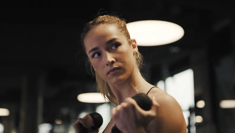 Close-up of a woman working out with dumbbells