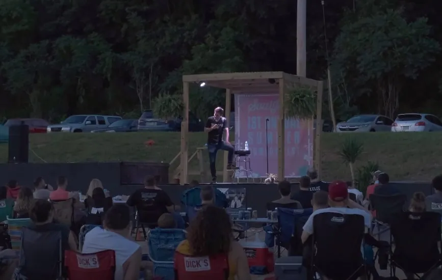 Man performs open air stand-up comedy