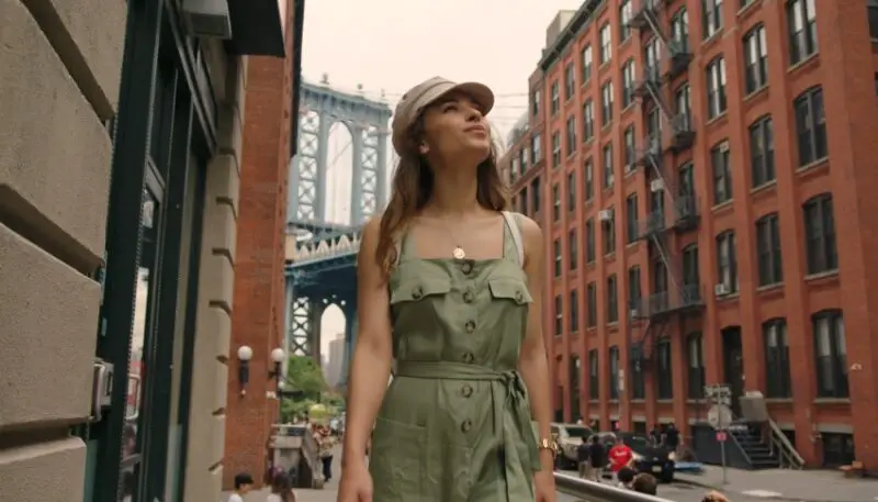 A woman strolls through the city, taking in the sights of the Manhattan Bridge