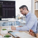 A team reviews logistics data on a screen during a meeting, reflecting the rise of New York tech firms