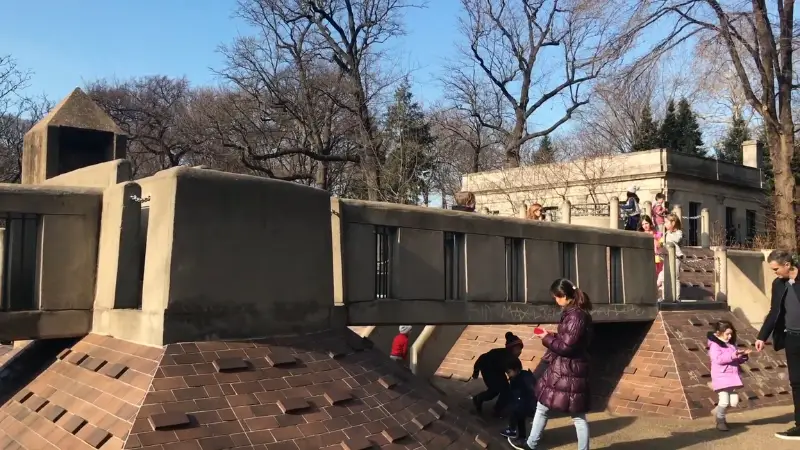 Ancient Playground in Central Park with kids climbing and playing around pyramid-like structures
