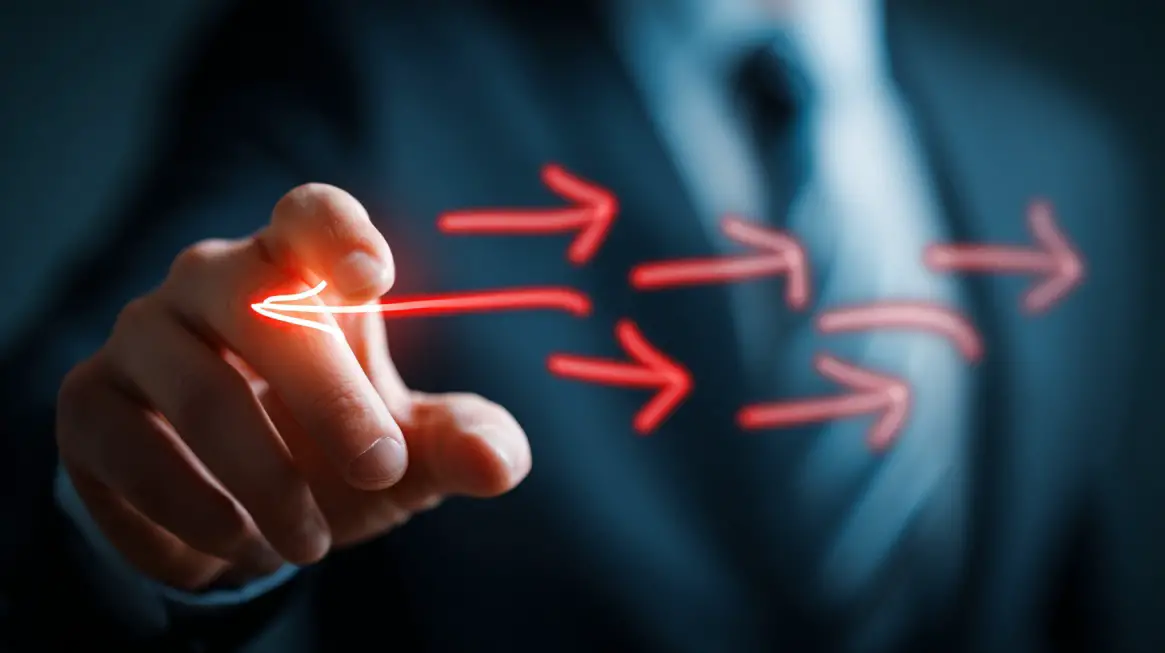 Close up of a hand pointing as glowing red arrows move forward