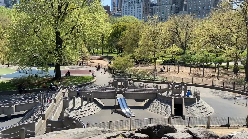 Heckscher Playground in Central Park with slides and wide play areas surrounded by trees and paths